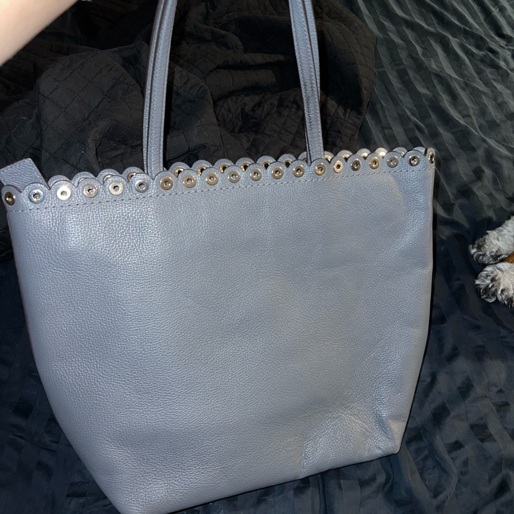 Kate Spade tote gray color with scalloped trim. Zips closed.
